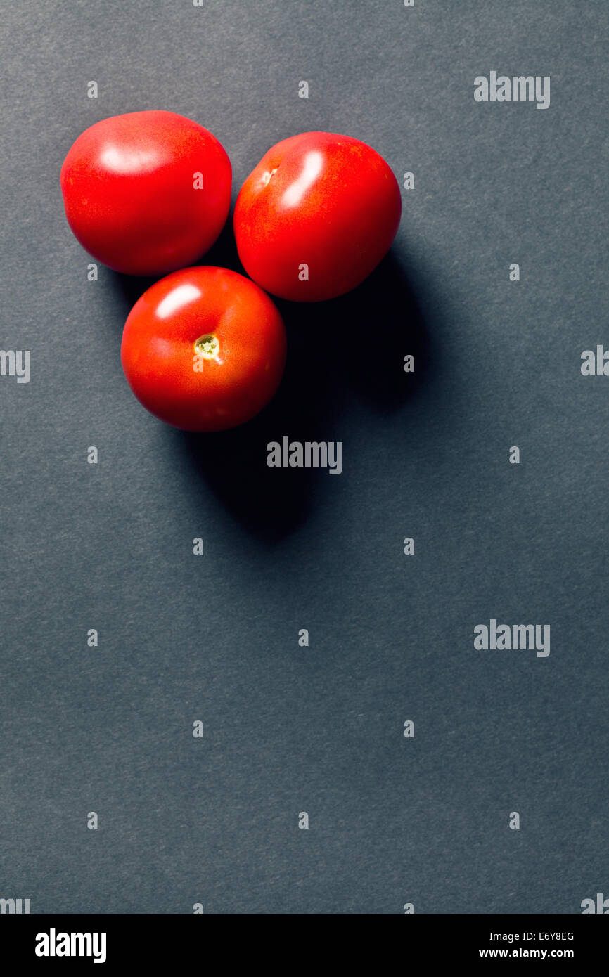 red tomatoes on black background Stock Photo - Alamy