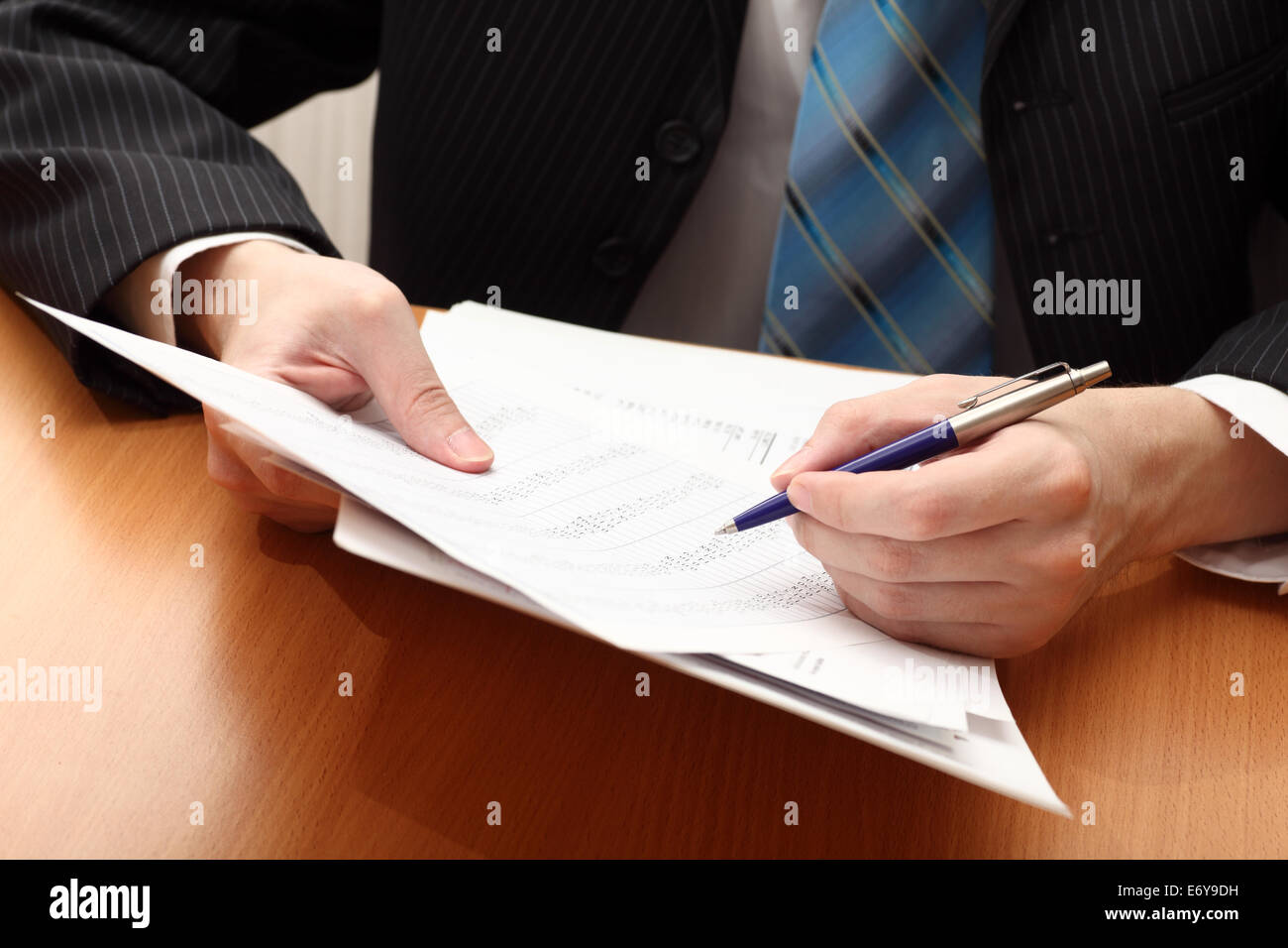 Businessman viewing financial statements. Stock Photo