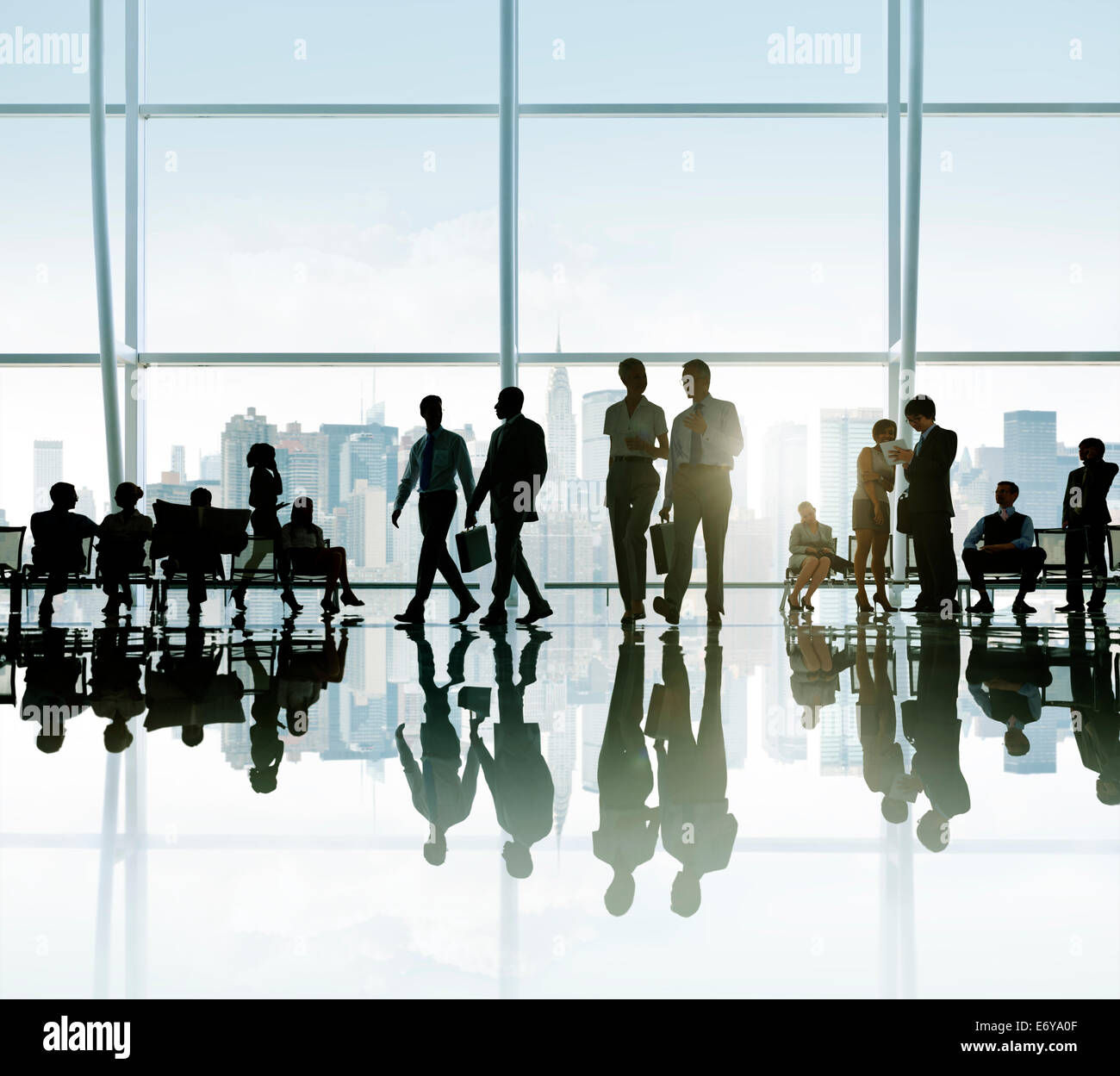 Silhouette of a large diverse group of business people having a break ...