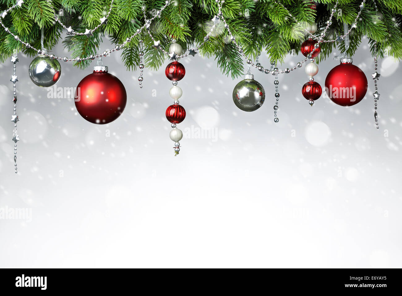 Christmas balls hanging on snowy fir tree Stock Photo