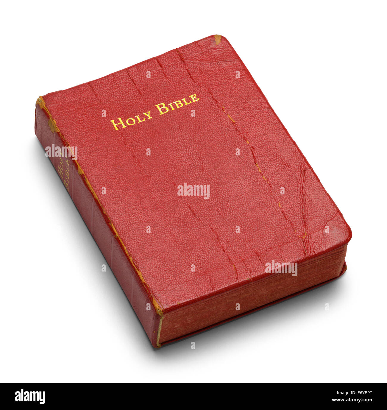 Well Used Bible with Red Pages Isolated on White Background. Stock Photo