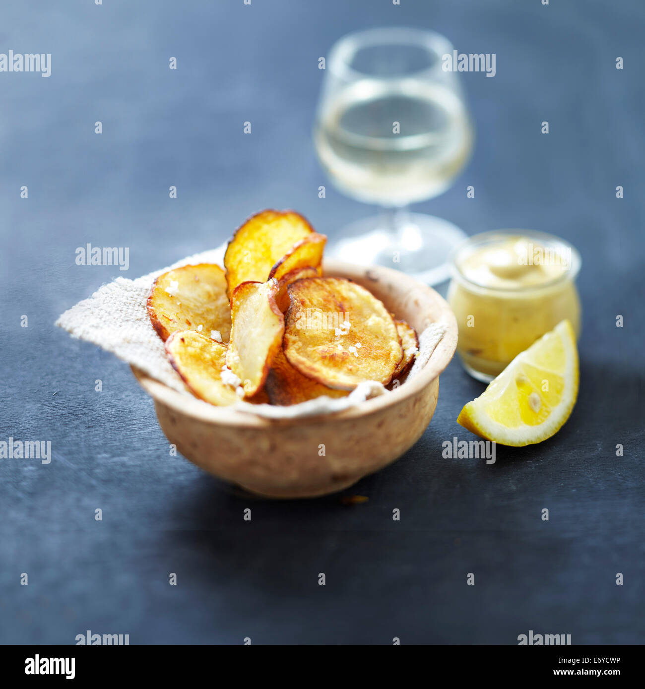 Potato crisps with lemon-flavored mustard Stock Photo