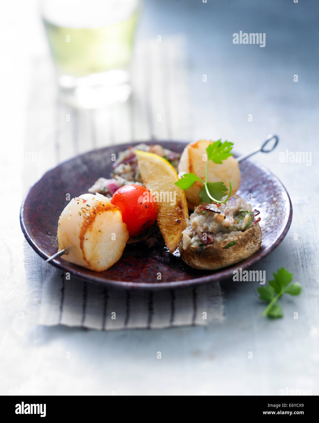 Scallop brochette with mushrooms stuffed with smoked duck magret Stock Photo