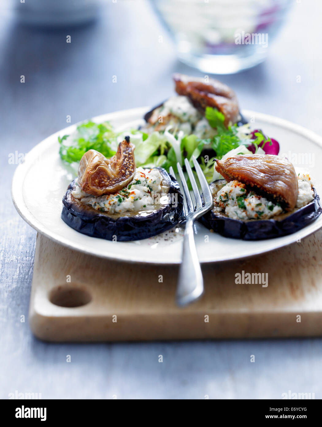 Sliced eggplants grilled with goat's cheese and fresh figs Stock Photo