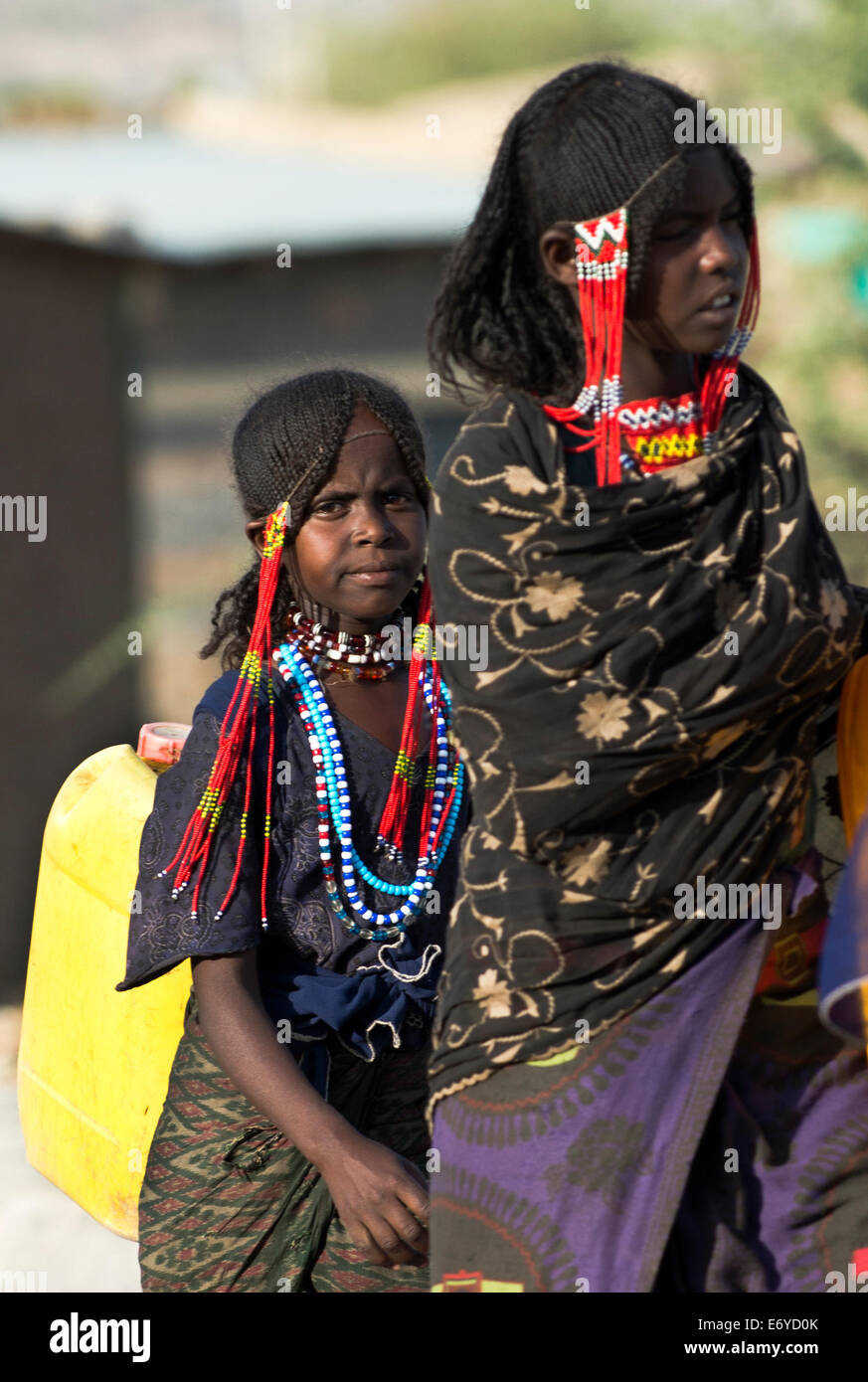 Afar girls bring water back to their home Stock Photo - Alamy