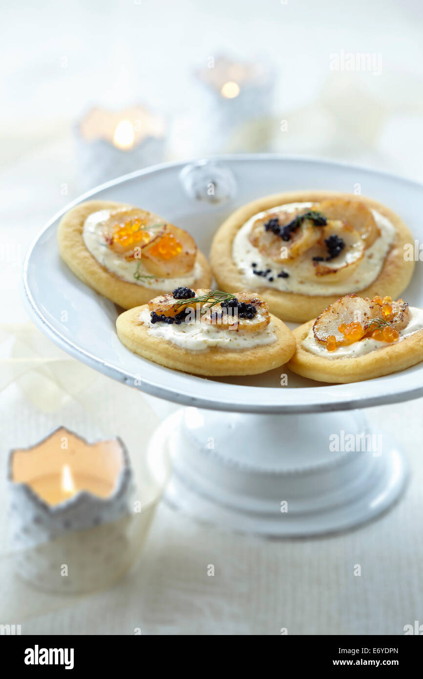 Blinis with scallops and fish roe Stock Photo