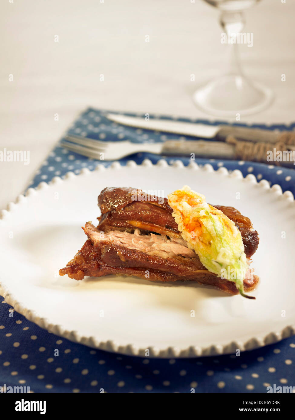 Lamb collar with a zucchini flower fritter Stock Photo