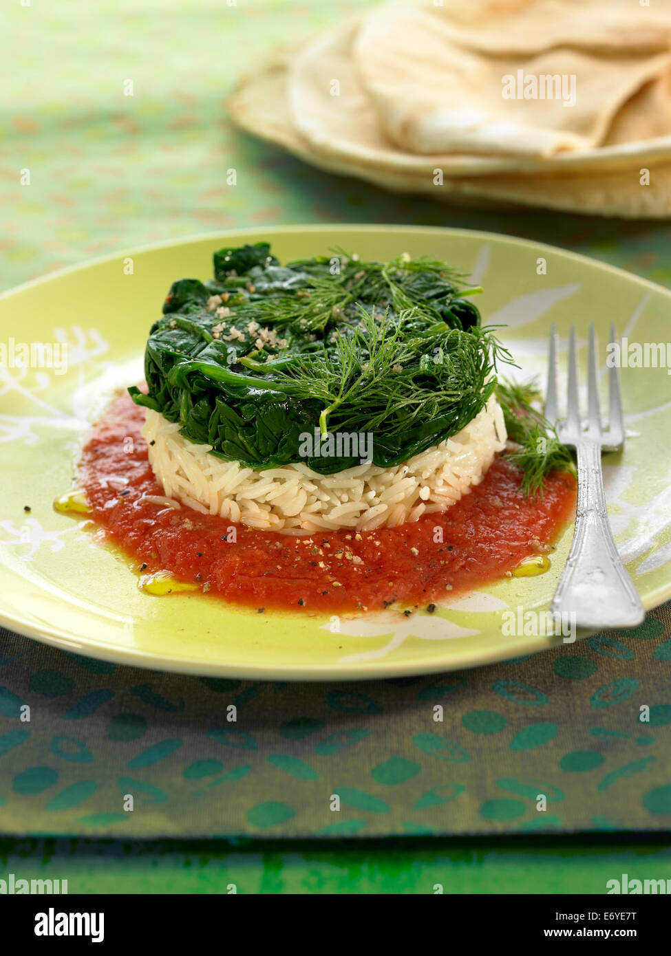 Basmati rice and spinach timbale with tomato sauce Stock Photo