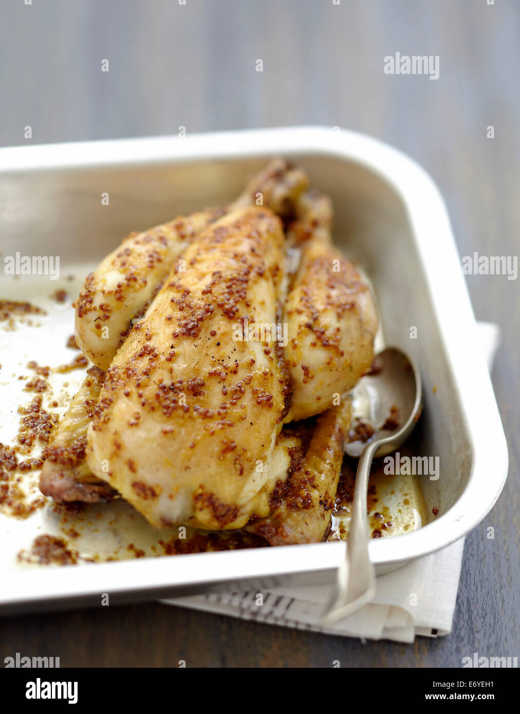 Cockerel coated in maple syrup and mustard seeds Stock Photo