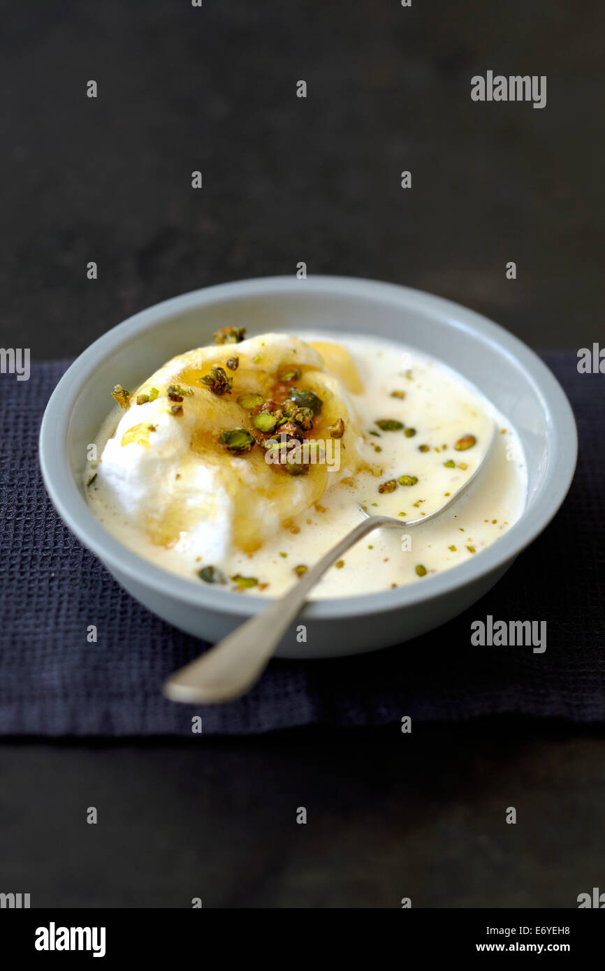 Beaten egg whites in cream with pistachios Stock Photo