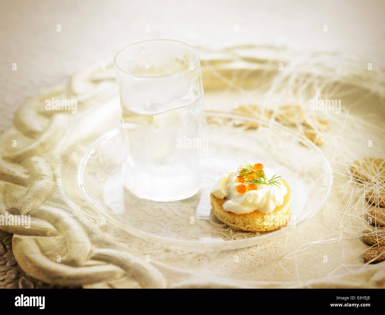 Glass of vodka and fish roe canapé Stock Photo