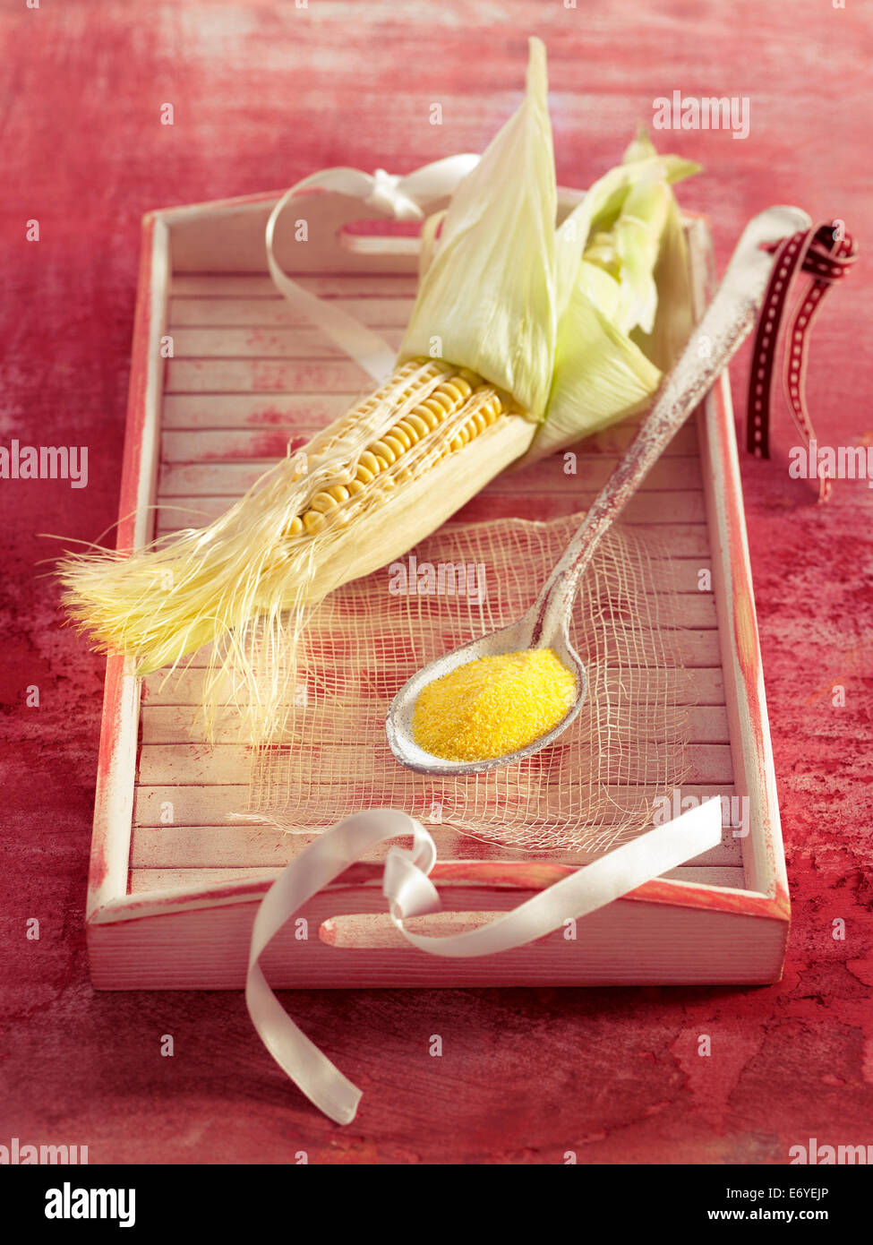 Corn on the cob and a spoonful of polenta Stock Photo