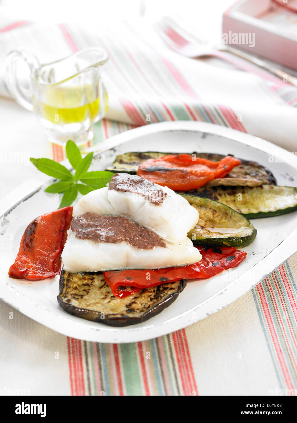 Salt cod with tapenade,grilled eggplants and red peppers Stock Photo