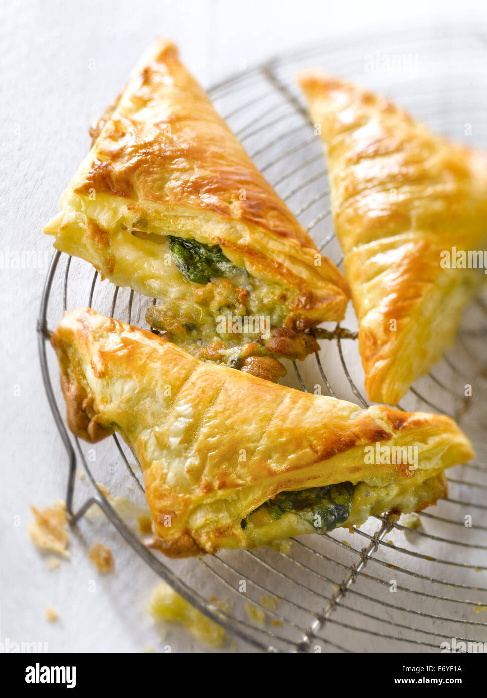 Spinach-roquefort flaky pastry triangular pies Stock Photo