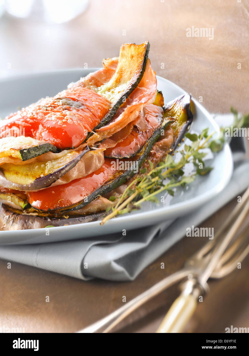 Grilled and layered vegetables and Parma ham Stock Photo