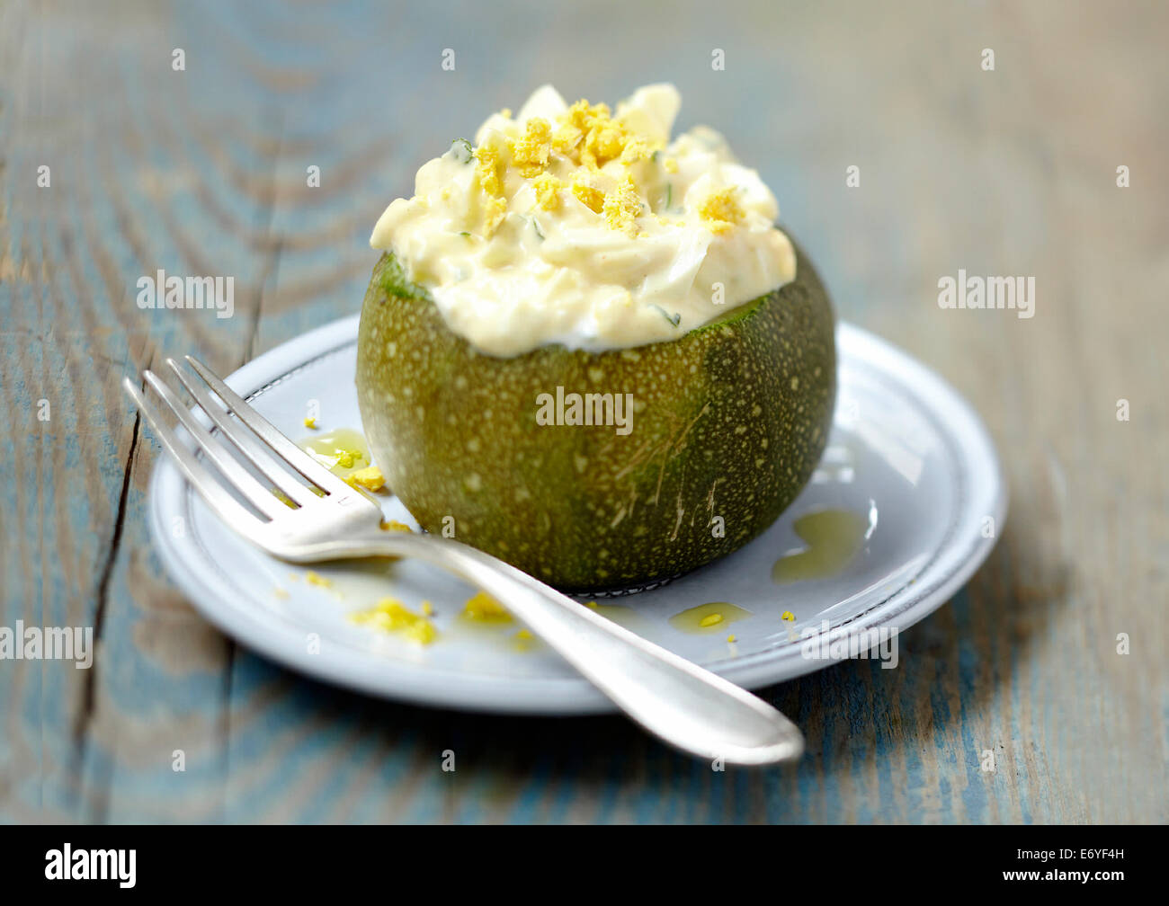 Round zucchini with egg mimosa Stock Photo