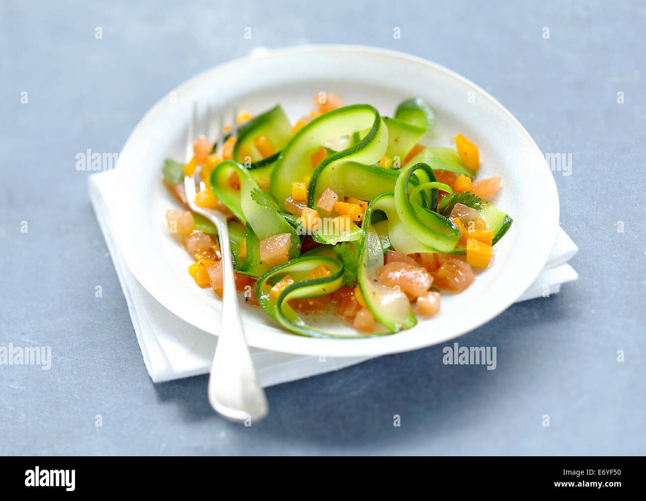 Zucchini strips with crushed tomatoes Stock Photo
