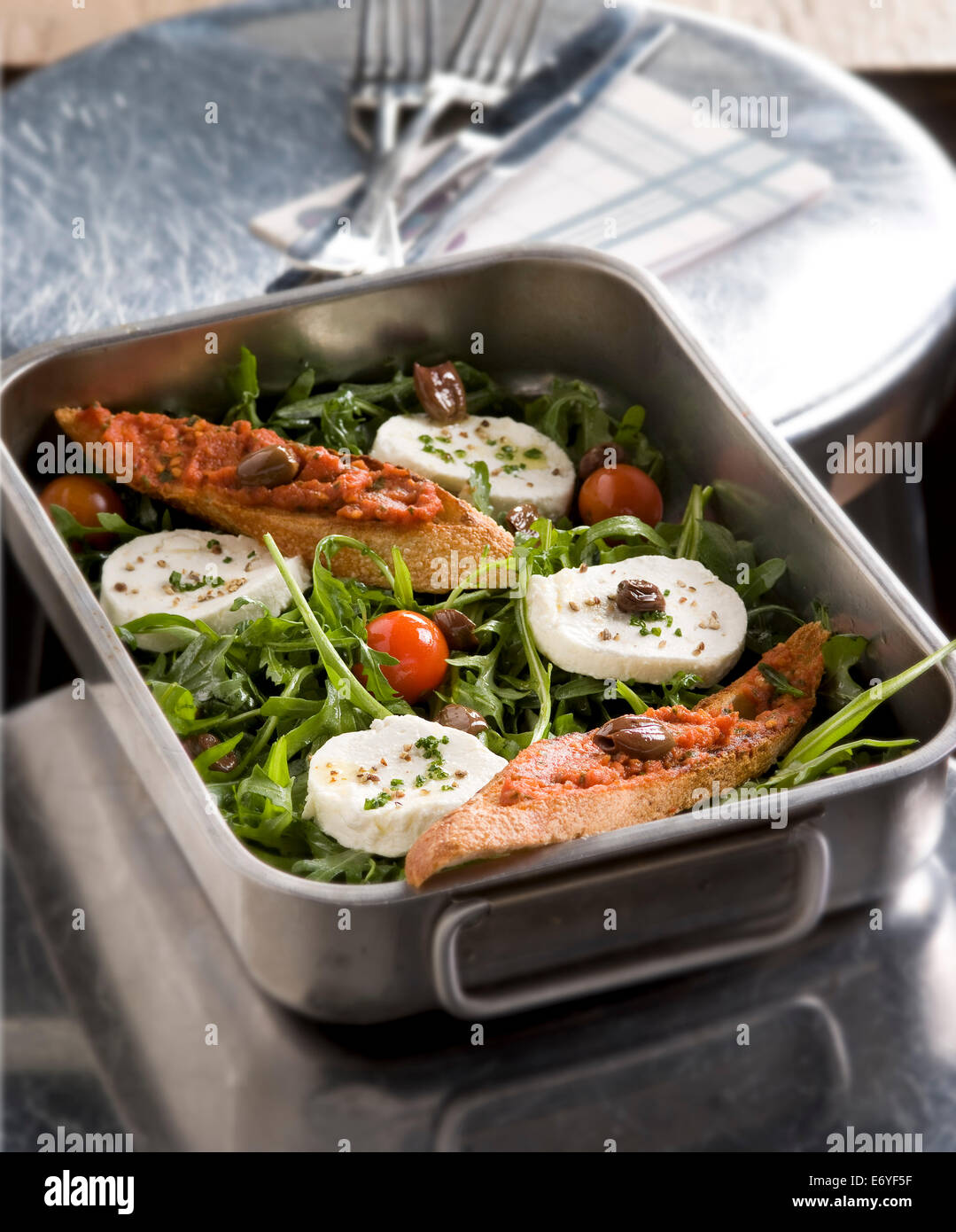 Bruschettas on a bed of rocket lettuce with mozzarella Stock Photo