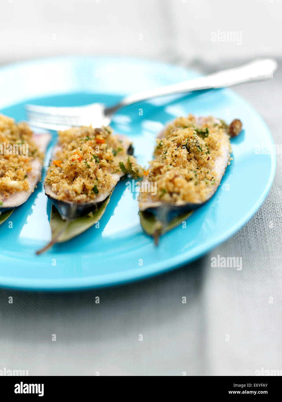 Sardines stuffed with pine nuts,bread crumbs and raisins,bay leaves and orange sauce Stock Photo