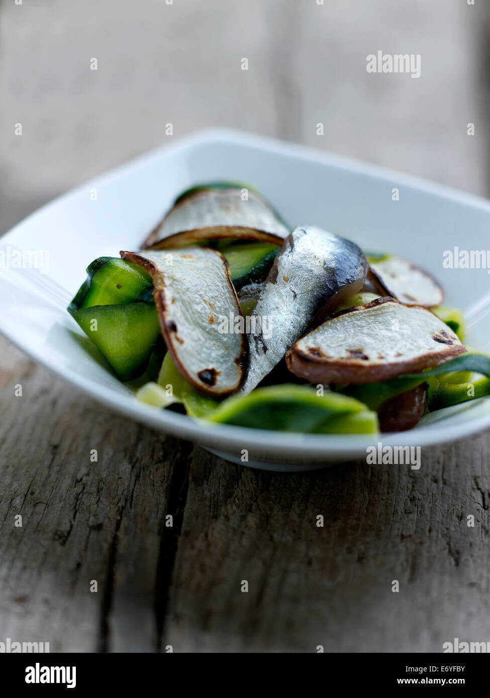 Thin strips of zucchini with anchovies and sauteed turnips Stock Photo