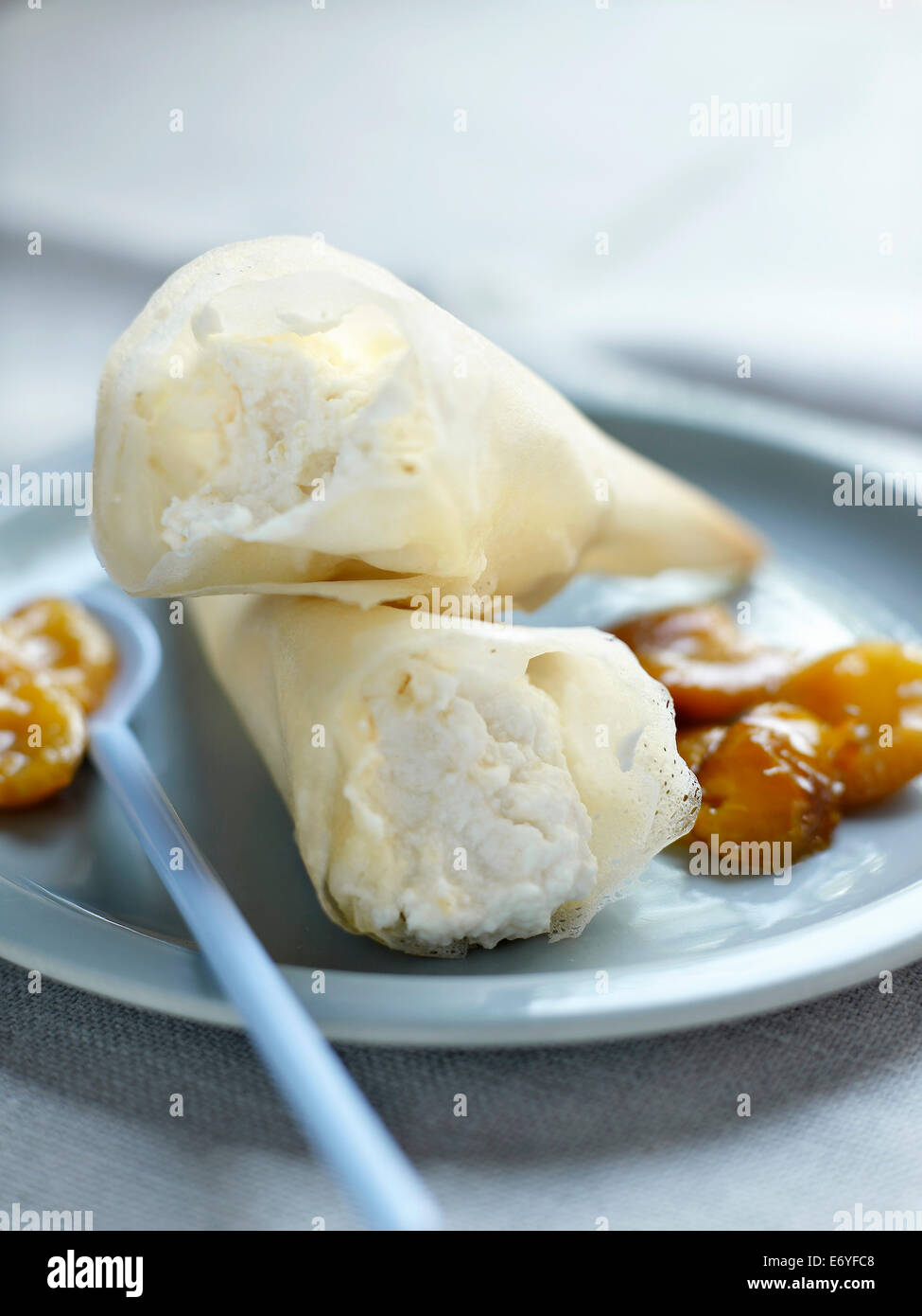 Filo pastry cones filled with ricotta and mirabelle plums Stock Photo