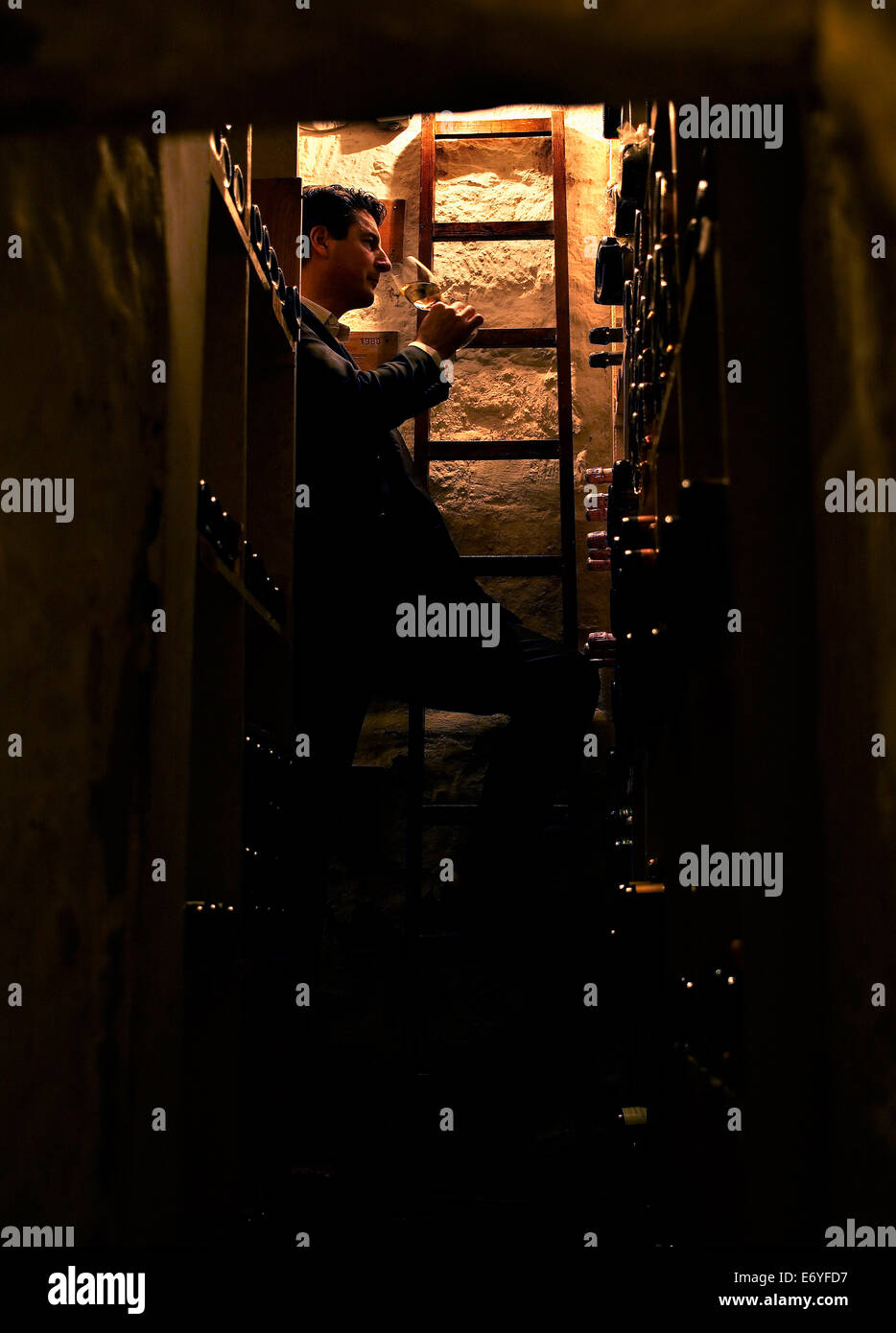 Person tasting wine in a cellar Stock Photo