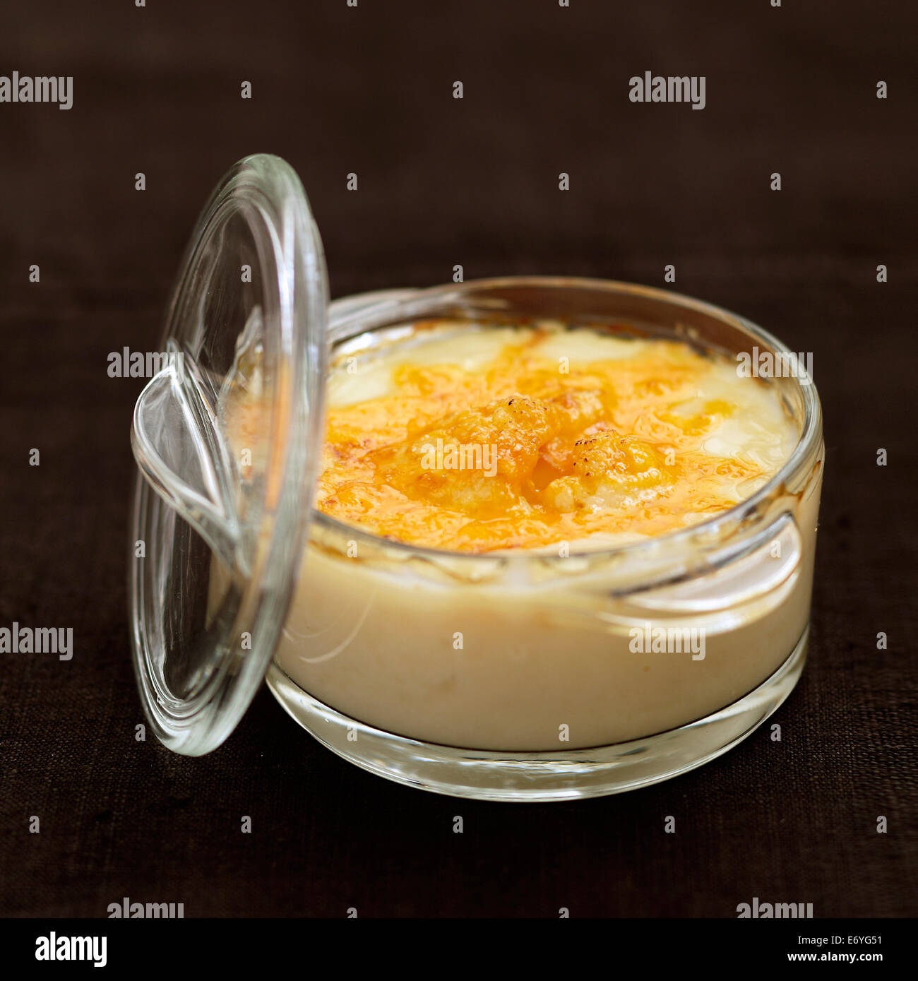 Cream of artichoke soup topped with grilled cheddar Stock Photo
