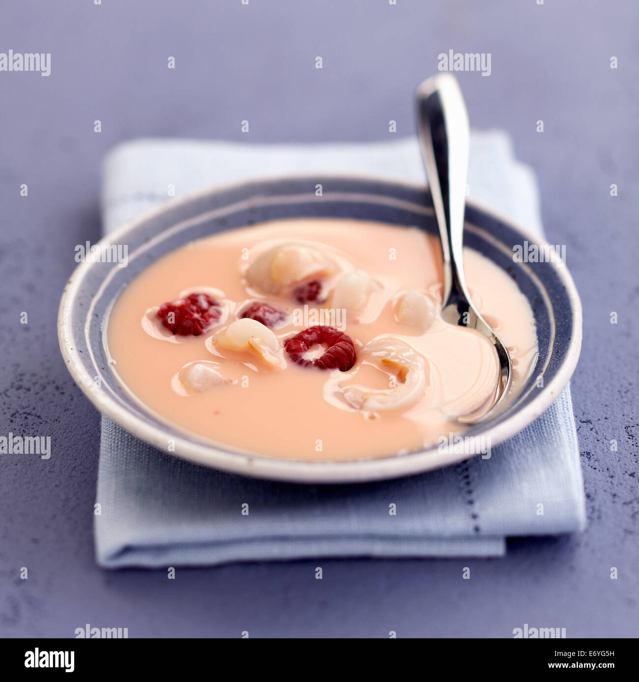 Rose water cream dessert with lychees and raspberries Stock Photo