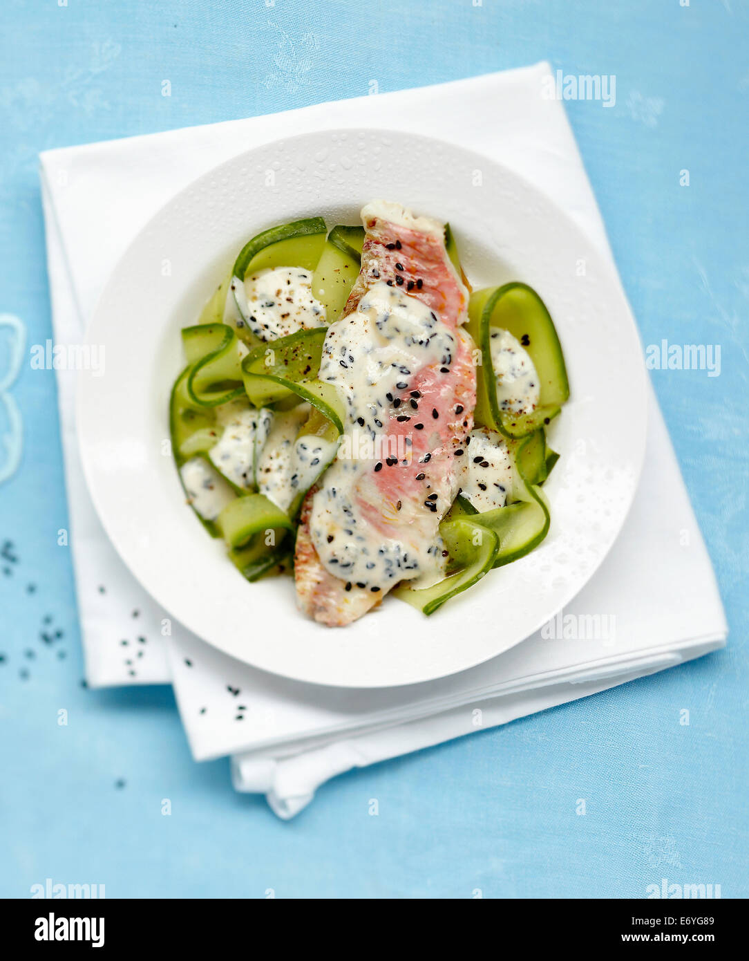 Red mullet and zucchinis with yoghurt and black sesame sauce Stock Photo