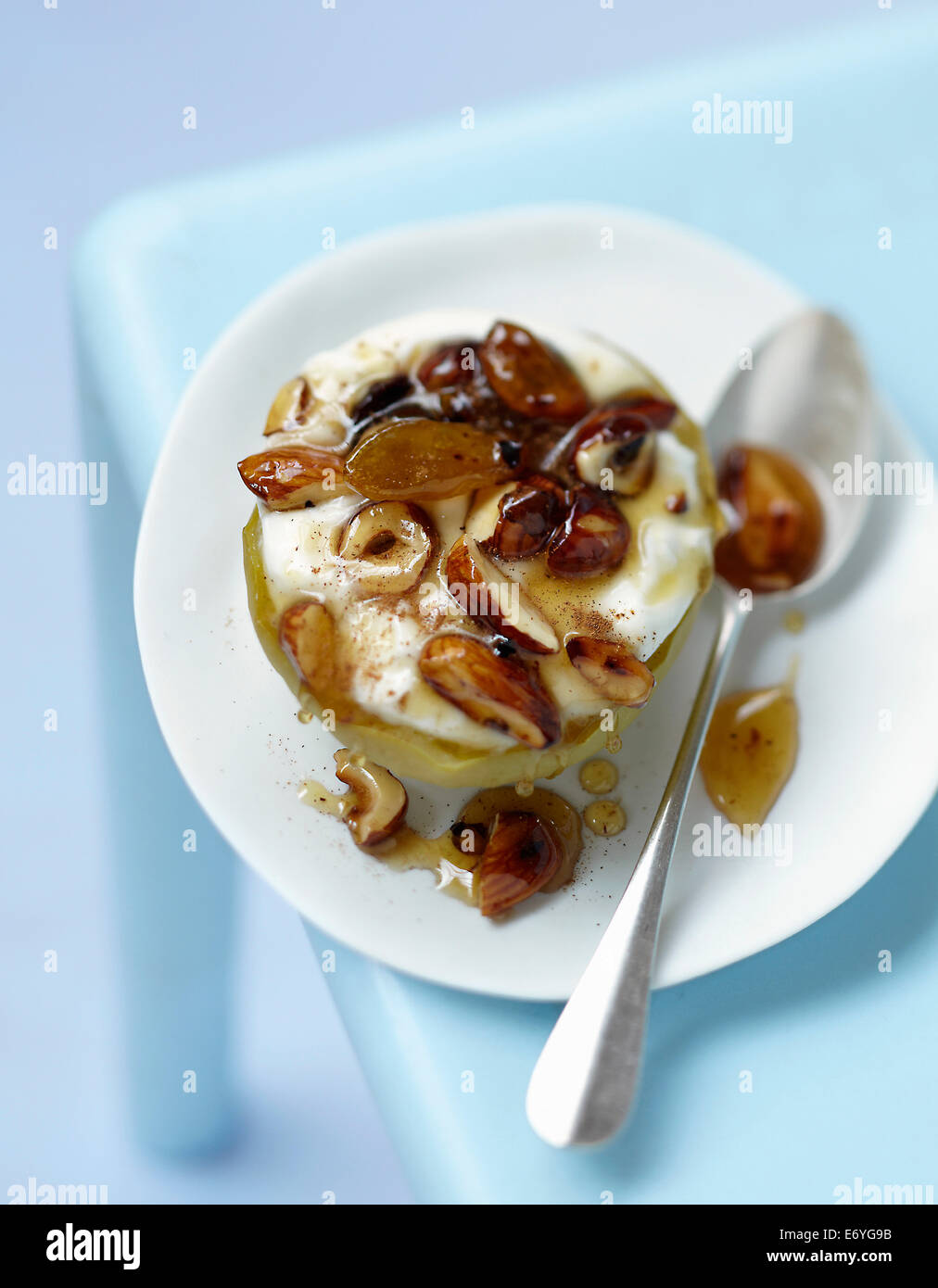 Granny Smith apple stuffed with dried fruit and honey Stock Photo