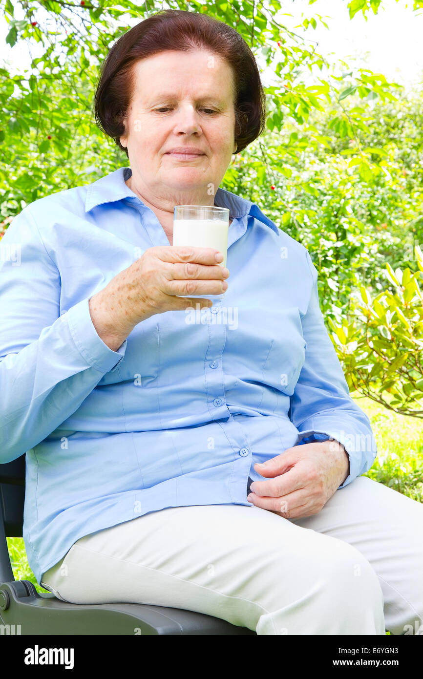 Portrait of senior woman drinking milk Stock Photo Alamy