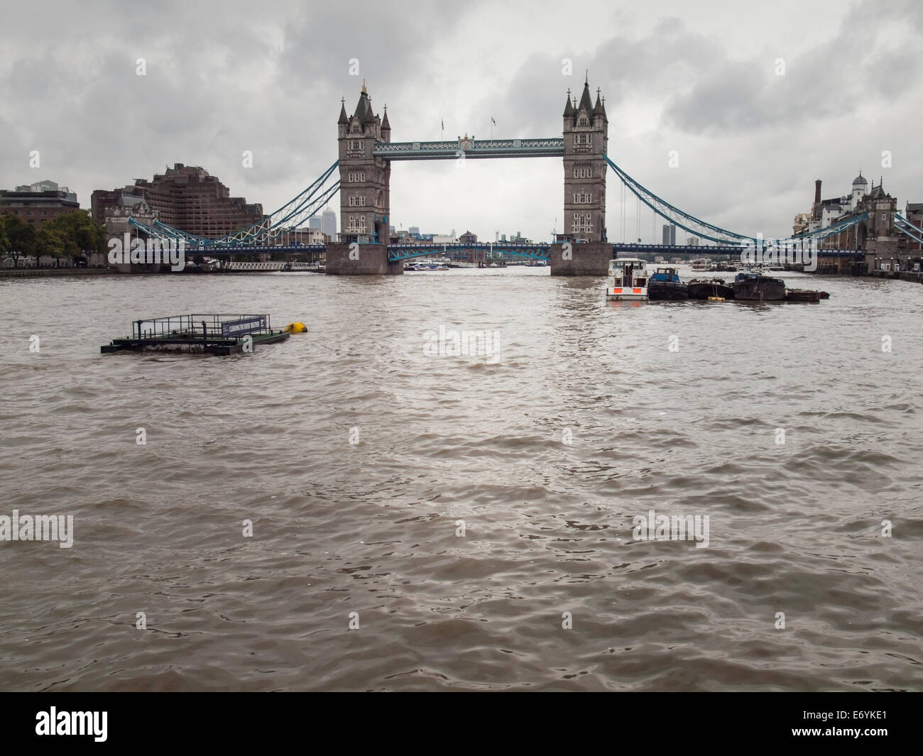 tower bridge london viewed from the river thames on an overcast day under grey sky. Stock Photo