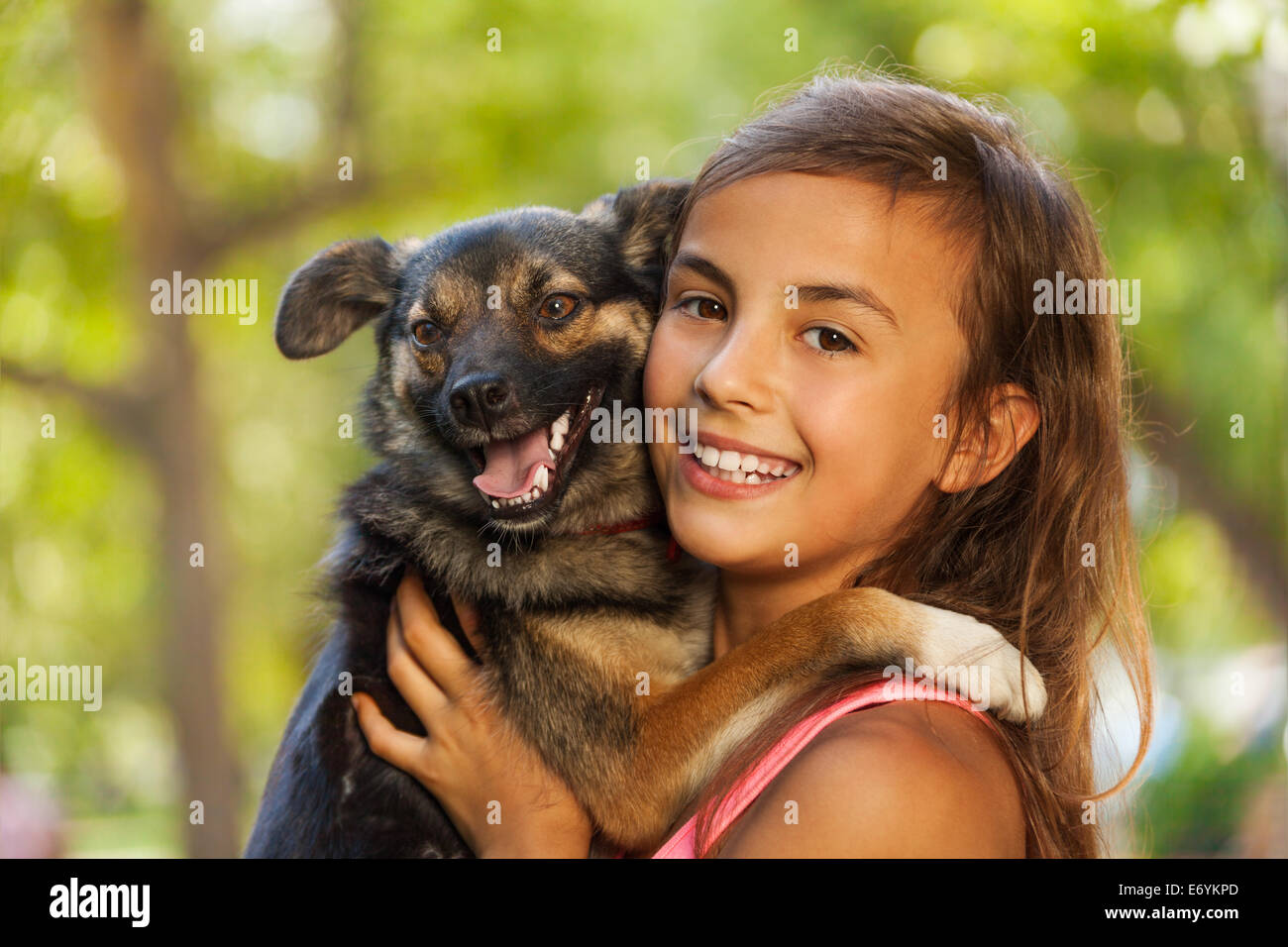 Close teenage girl portrait in hugging little dog Stock Photo - Alamy