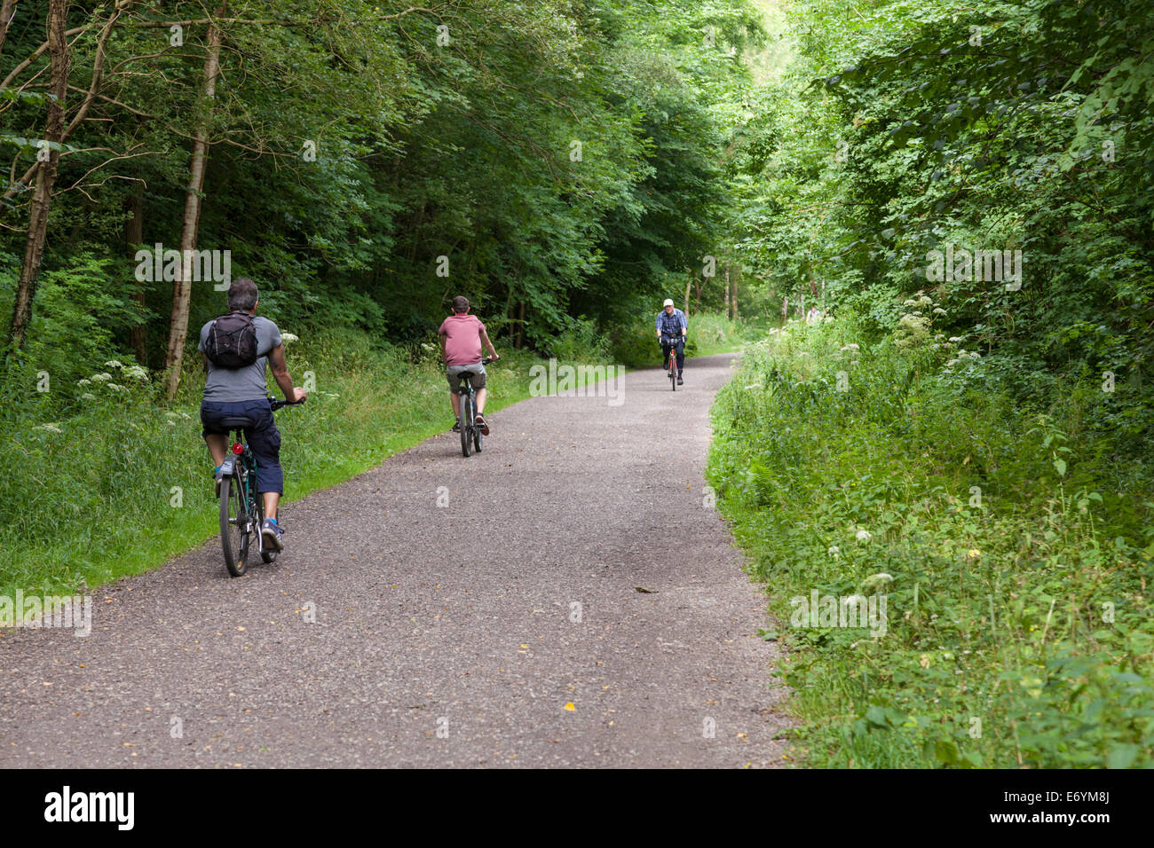Cyclists on a cycle path in the Peak District. Cycling on the Monsal Trail, Derbyshire, Peak District National Park, England, UK Stock Photo