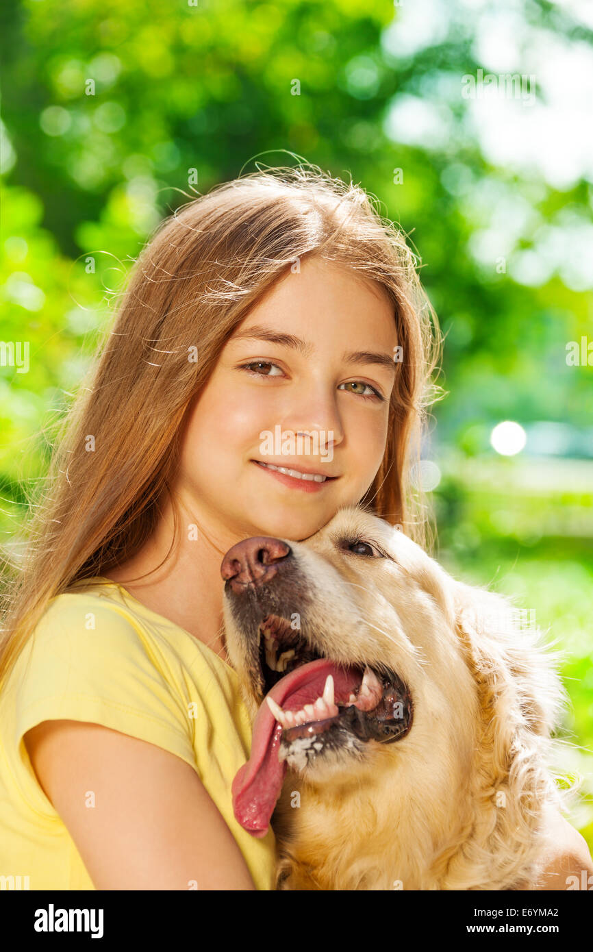 Happy teenage girl hugging dog outside portrait Stock Photo - Alamy
