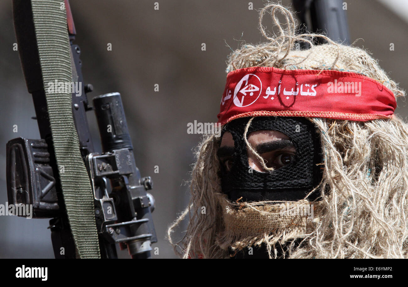 Gaza. 2nd Sep, 2014. A Palestinian militant from the Popular Front for the Liberation of Palestine (PFLP) takes part in a military parade one week after the Egypt-mediated ceasefire between Israel and Hamas in Gaza city, on Sept. 2, 2014. Credit:  Yasser Qudih/Xinhua/Alamy Live News Stock Photo