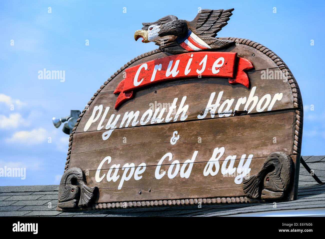 An ornate carved wooden sign for Cruises from Plymouth Harbor and Cape Cod Bay. Plymouth, Massachusetts - USA. Stock Photo