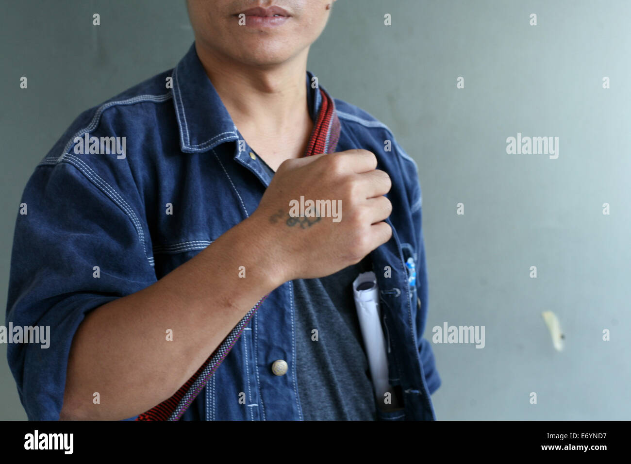 Sept. 1, 2014 - Chiang Mai, Thailand - U Gambira, the mastermind behind the Saffron revolution in 2007 in Myanmar posing with his tattoo stating Nyi Nyi.. Nyi Nyi was Gambiras childhood name while u Gambira his spiritual Buddhist name.U Gambira is the leader of the All Burma Monk Alliance and one of Myanmar's most prominent political prisoners..He was regarded as a prisoner of conscience by Amnesty International.He won many human rights awards including the Bindmans Law and Campaigning Award in absentia at the 2008 index to cencorship Freedom of Expression AwardsIn 2013 Gambira vanished from M Stock Photo