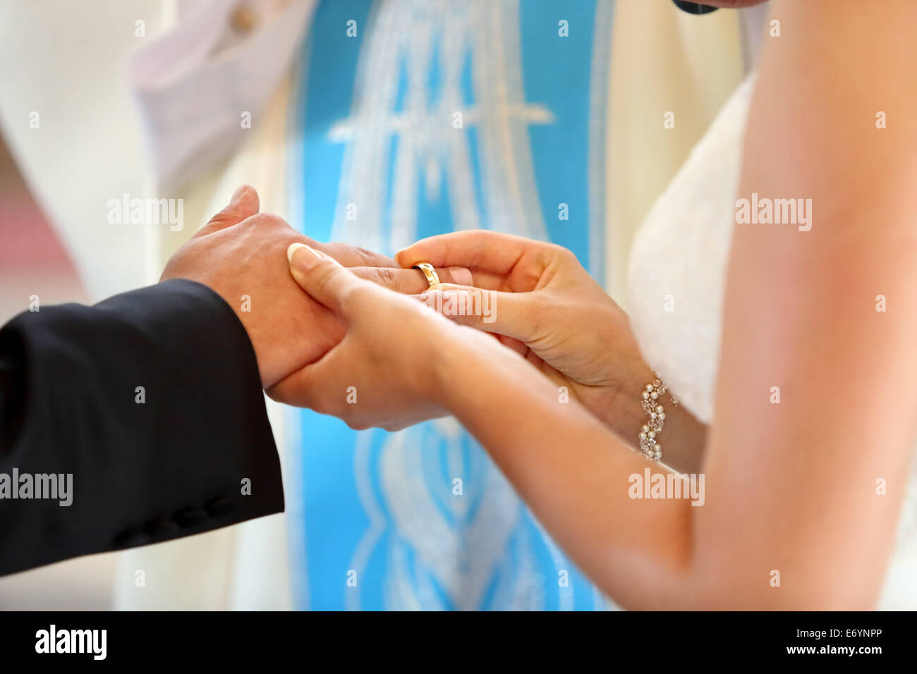 Couple having their wedding ceremony in church in front of a catholic