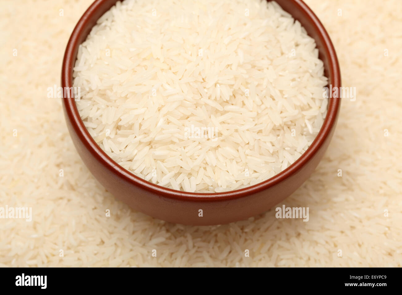 Long rice in bowl on rice background. Shallow depth of field. Closeup. Stock Photo