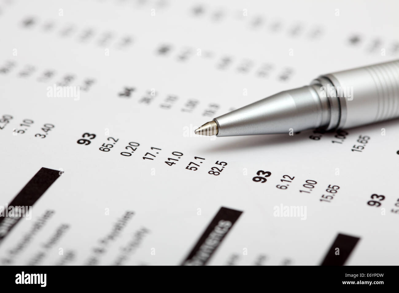 Analysis of financial statements. Focus on pen. Shallow depth of field. Closeup. Stock Photo