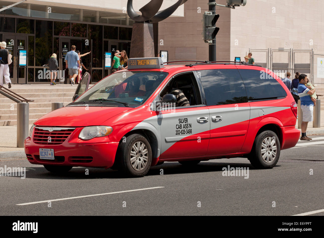 Minivan taxi displaying new uniform paint color scheme - Washington, DC USA Stock Photo