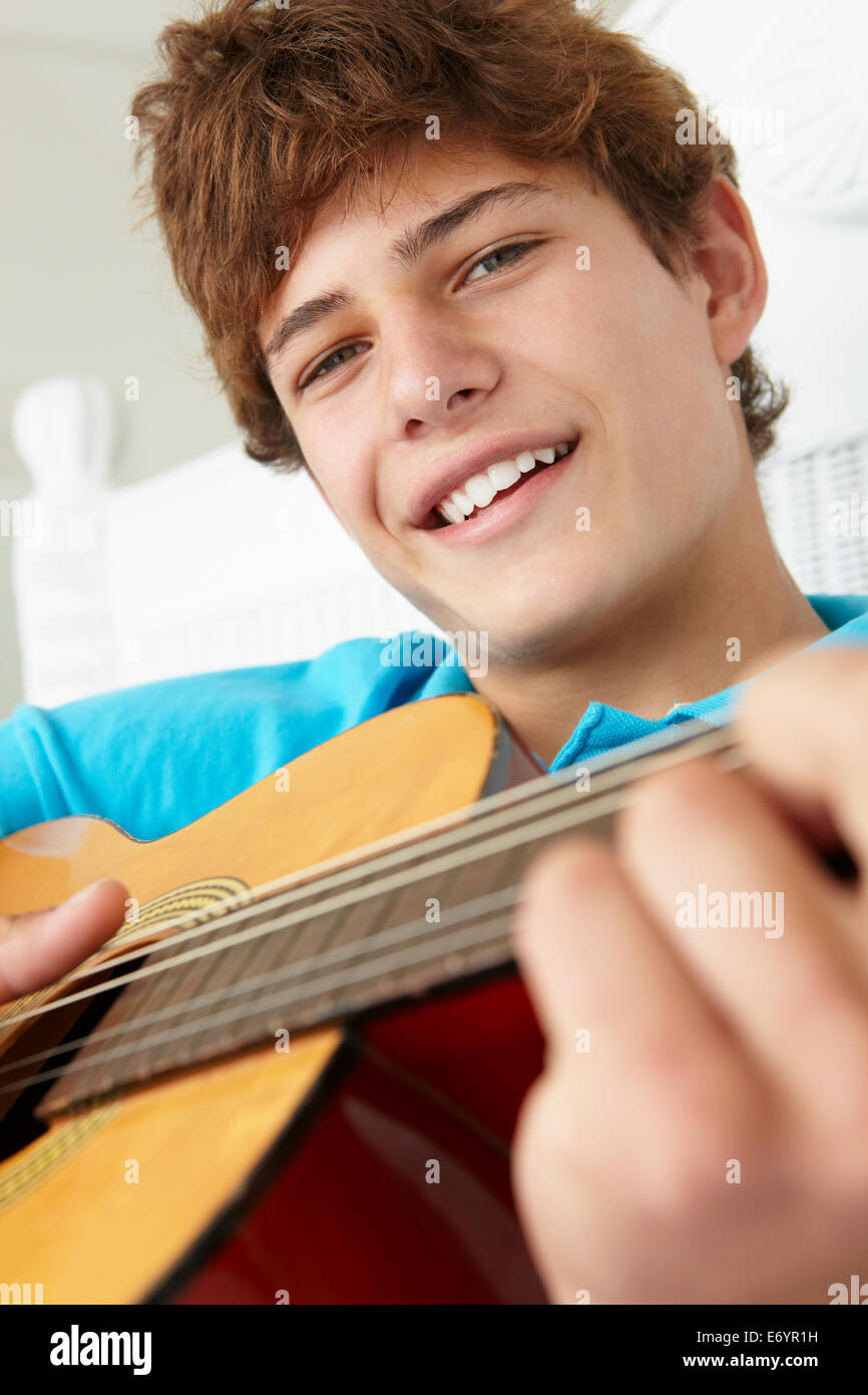 Teenage boy playing acoustic guitar Stock Photo