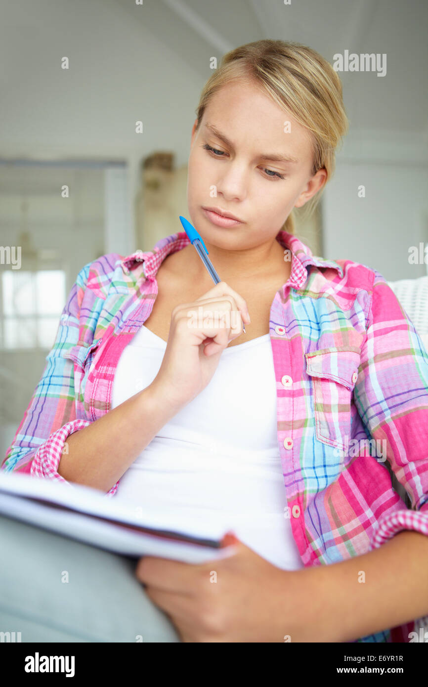 Teenage girl writing in notebook Stock Photo