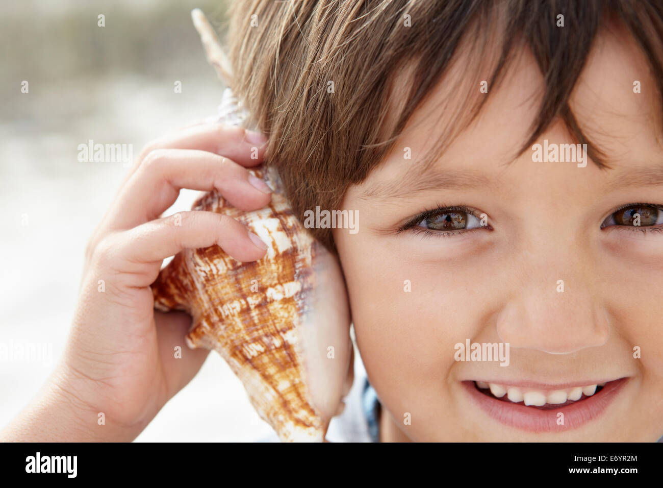 Young boy with seashell Stock Photo