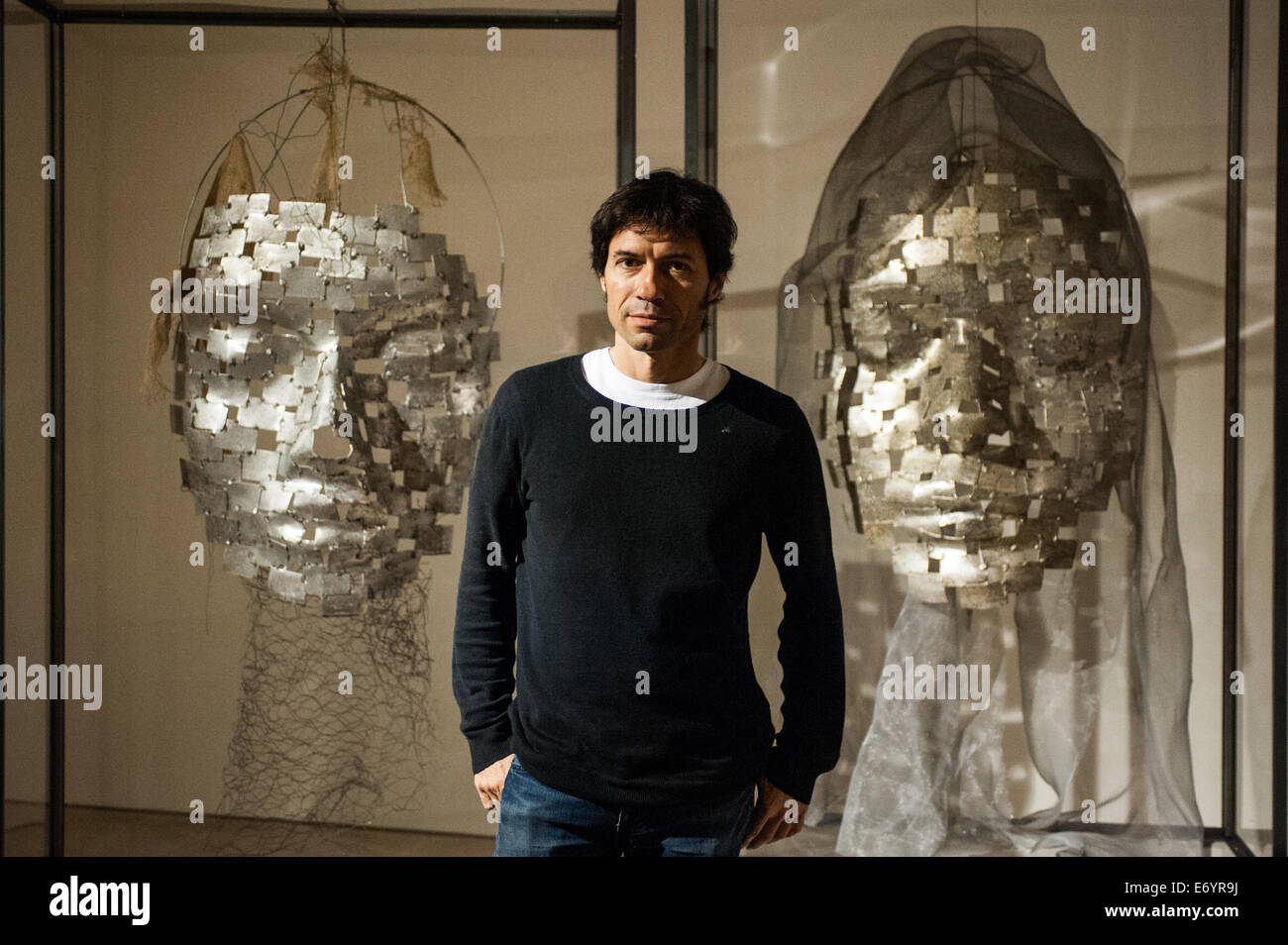 London, UK. 2nd Sept, 2014. Artist Xavier Mascaró poses next to his works 'Masks'. Xavier Mascaró's first UK solo exhibition will run from 3 September until 5 October at Saatchi Gallery. Credit:  Piero Cruciatti/Alamy Live News Stock Photo