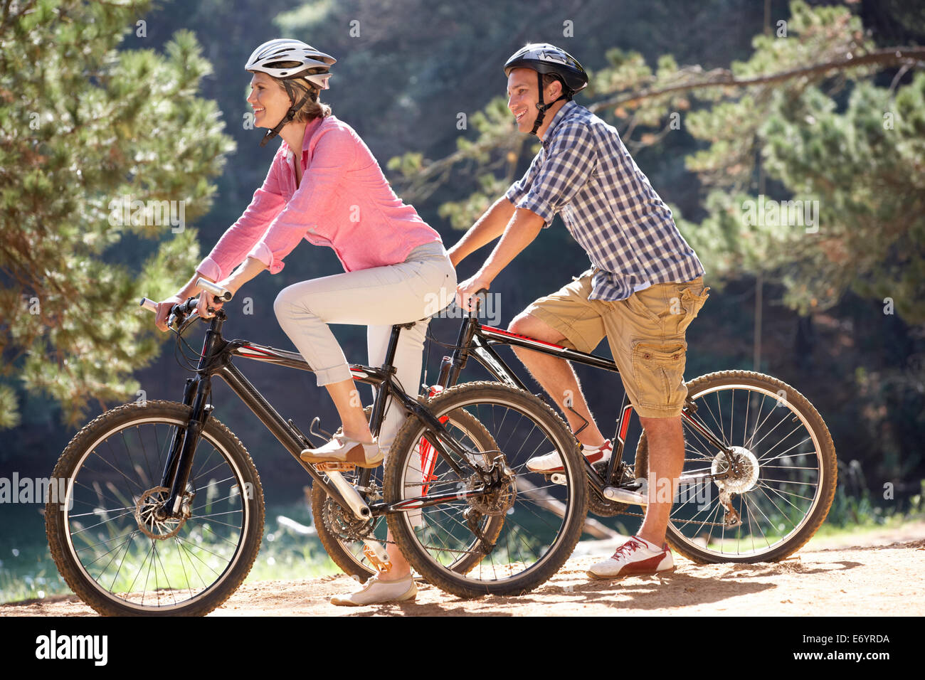 Couple cycling on forest track hi-res stock photography and images - Alamy
