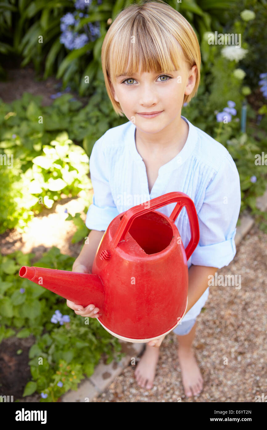 Young girl with watering can Stock Photo Alamy