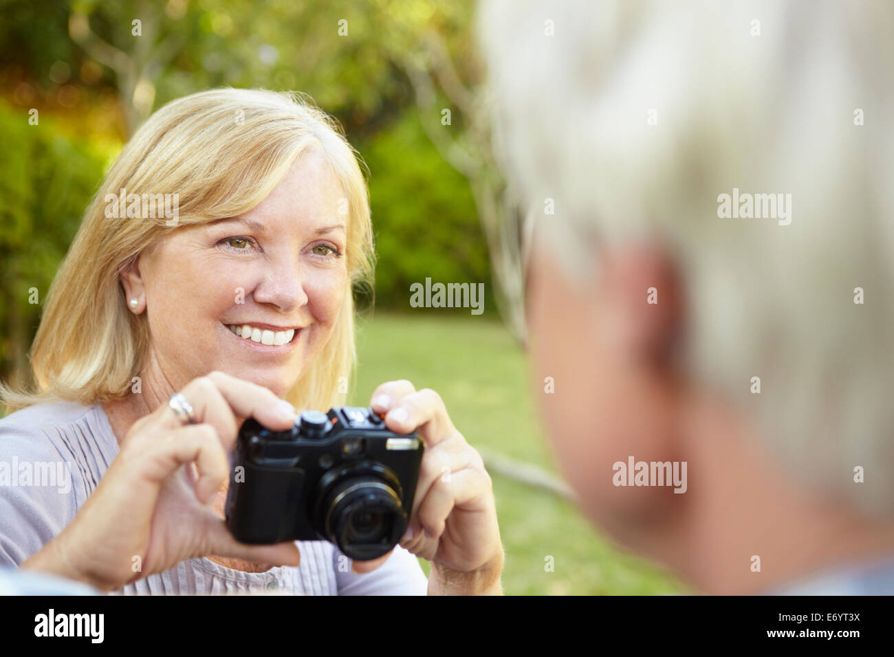 Senior couple taking photo outdoors Stock Photo