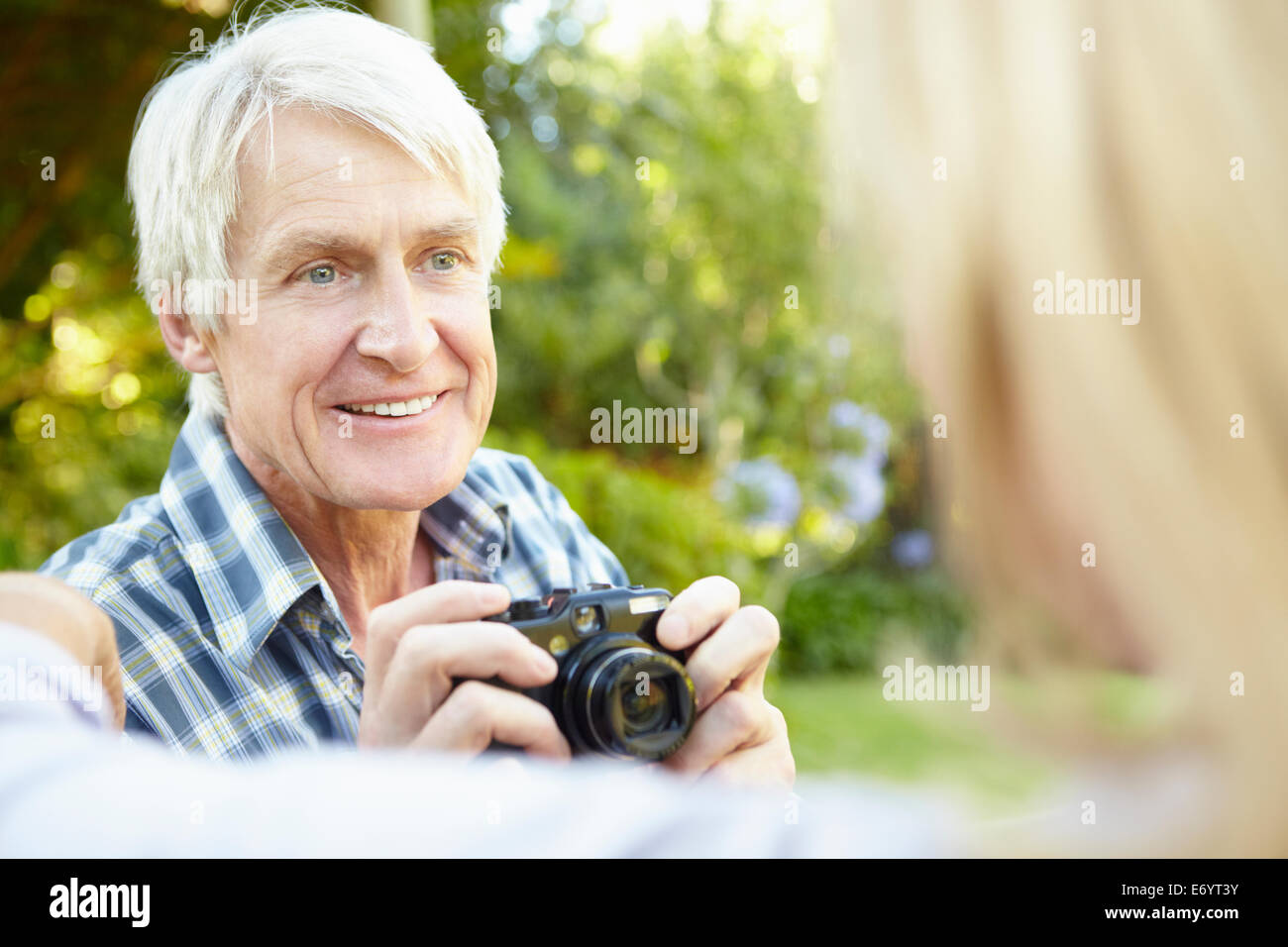 Senior couple taking photo outdoors Stock Photo